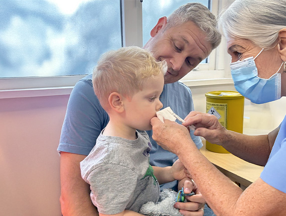 A young boy is receiving the child flu vaccination