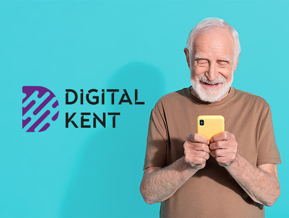 An elderly gentleman looking at his phone and smiling at the screen. Digital Kent logo on the side.